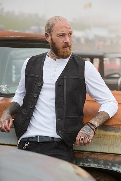 Style a graphic t-shirt with waistcoat